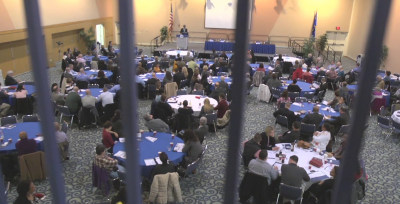 Gathering of the 2014 Building Bridges Meeting with view of speaker and attendants.