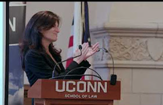 Women appaulding at a conference at UConn