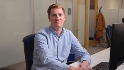 a man in a blue shirt looking at the camera