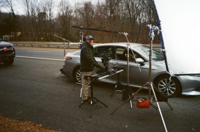 A film director next to a car