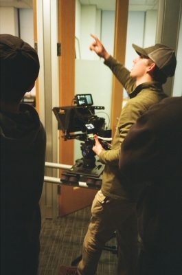 A man directing behind the camera