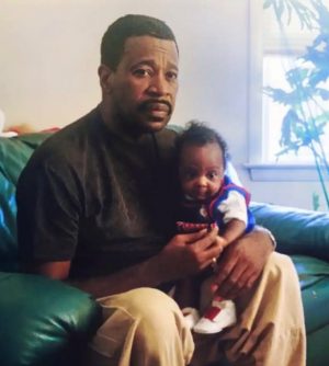 the late CT Sen. Alvin Penn holding his grandson, Sincere Valentine