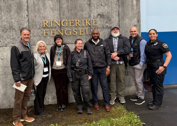 group of people posed outside building