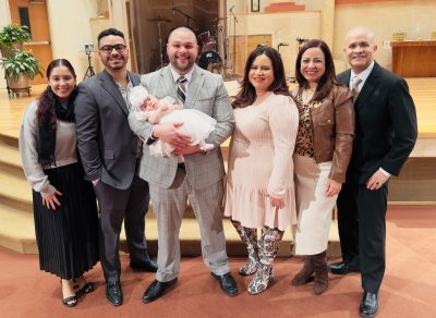 a family posing with a baby