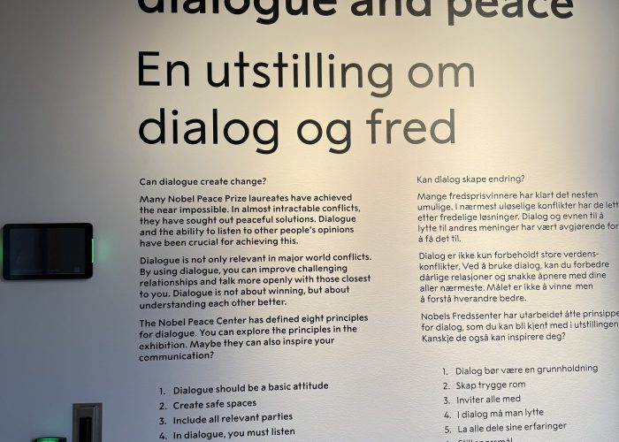 Museum display with text about dialogue and peace