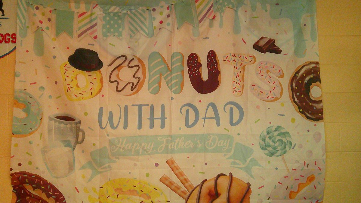 a sign with text that says "Donuts with Dads"