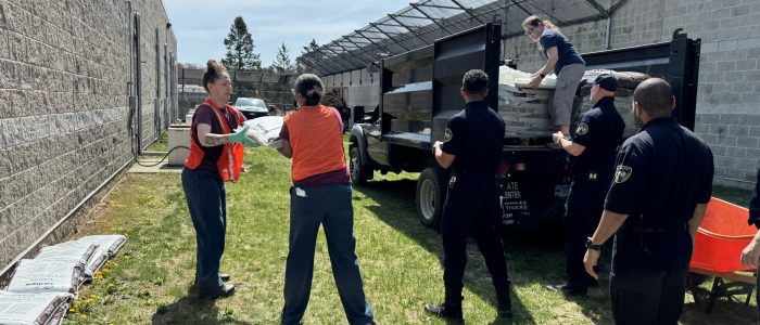 officers and inmates unload truck
